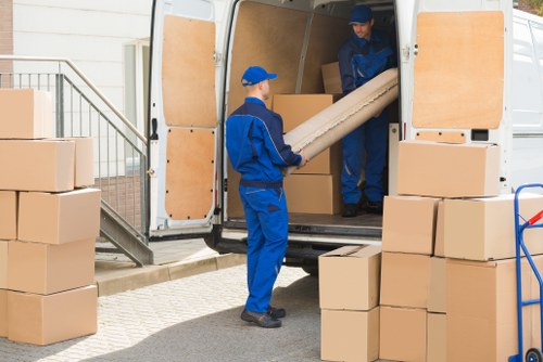 Removal team preparing a safe move with protective equipment and packing materials