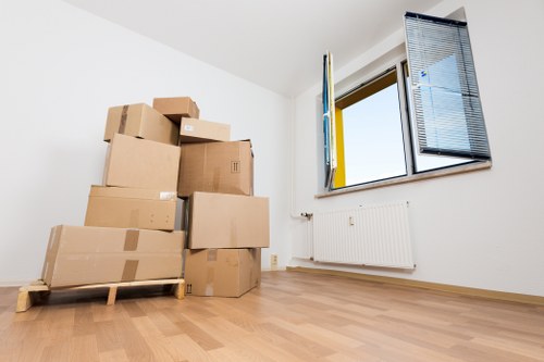 Staff using manual handling techniques and lifting aids during a house move