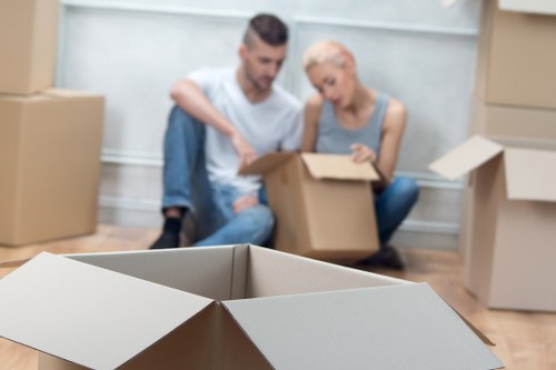 Experienced movers handling a piano move in a North London property