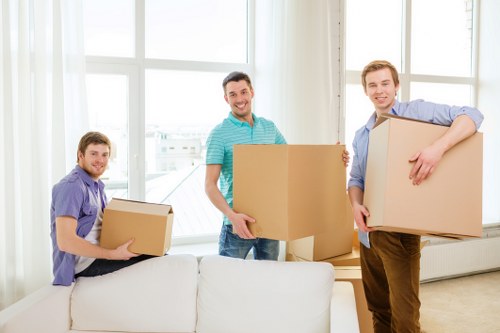Commercial movers organizing desks and IT equipment for transfer
