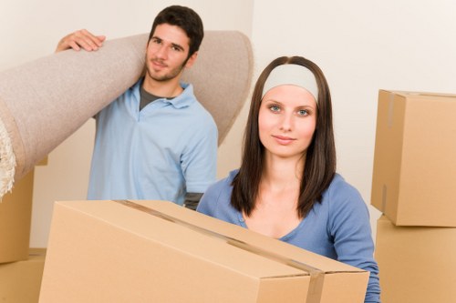 Mover carrying furniture carefully through a property entrance