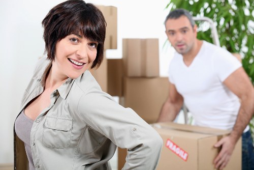 Operatives securing furniture and boxes safely inside a moving vehicle