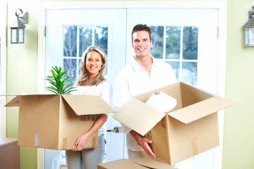 Team preparing bulky household furniture for transport in Northlondon